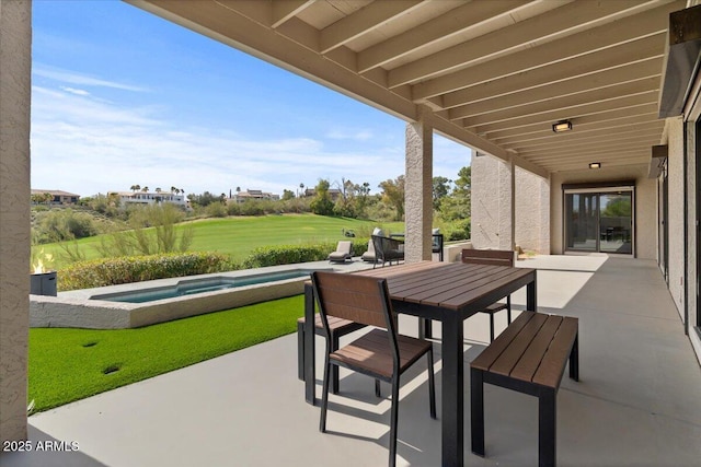 view of patio / terrace featuring a swimming pool with hot tub