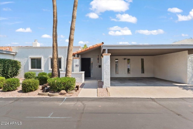 view of front of property featuring a carport