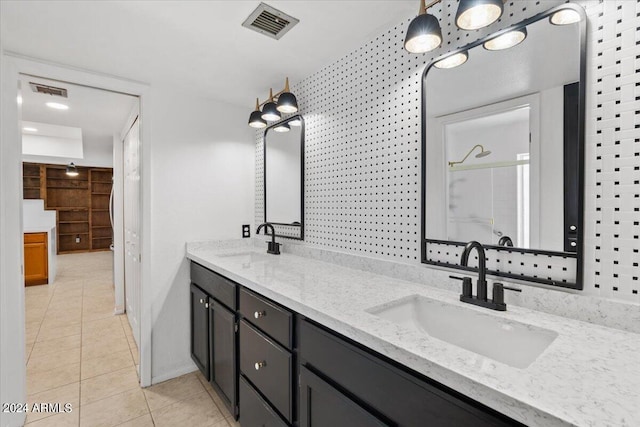 bathroom with vanity, walk in shower, and tile patterned flooring