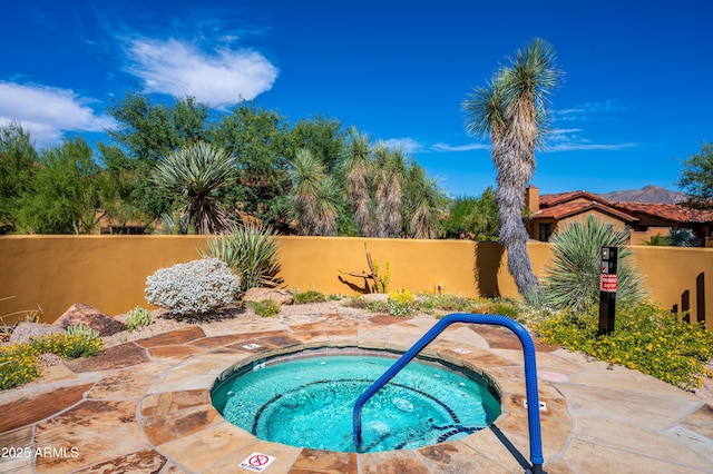 view of swimming pool with a community hot tub