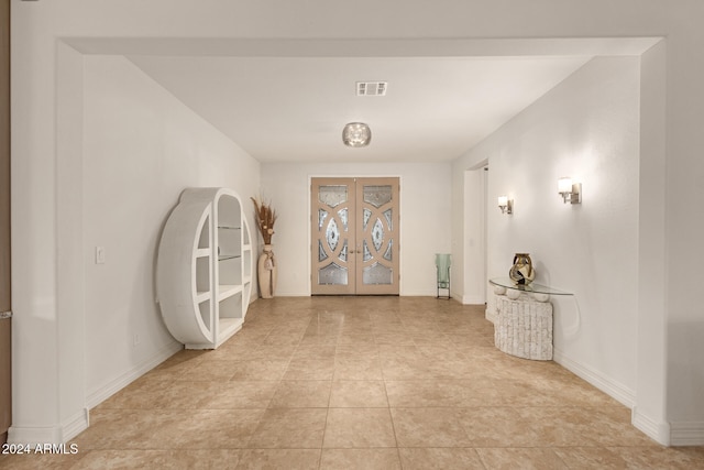 corridor featuring french doors and light tile patterned flooring