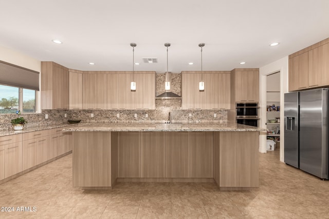 kitchen featuring light stone countertops, appliances with stainless steel finishes, sink, wall chimney range hood, and light brown cabinets