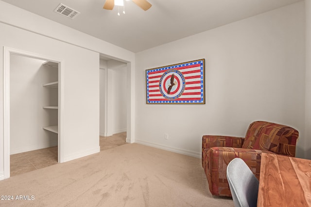 living area featuring ceiling fan and light carpet