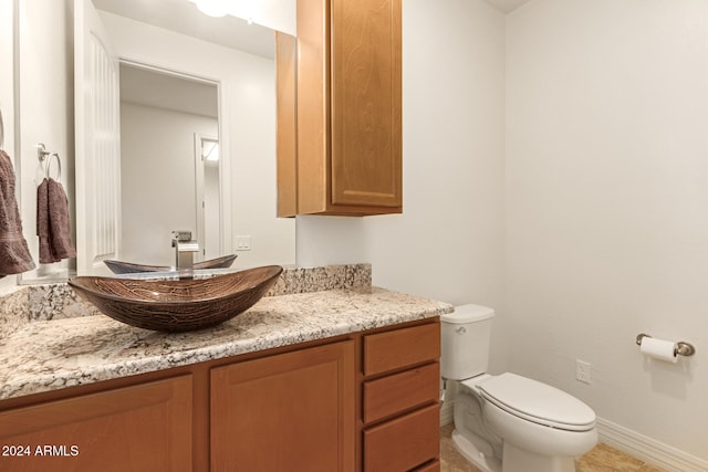 bathroom with tile patterned floors, vanity, and toilet