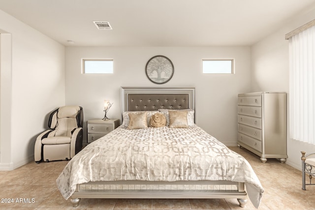 bedroom featuring multiple windows and light tile patterned floors