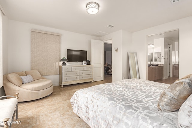 tiled bedroom featuring ensuite bathroom