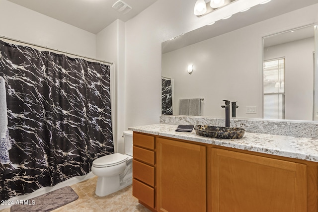 bathroom with tile patterned floors, vanity, and toilet