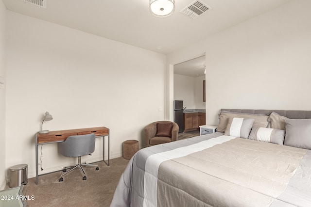 carpeted bedroom with stainless steel fridge