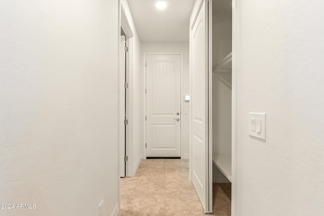 hall featuring light tile patterned floors