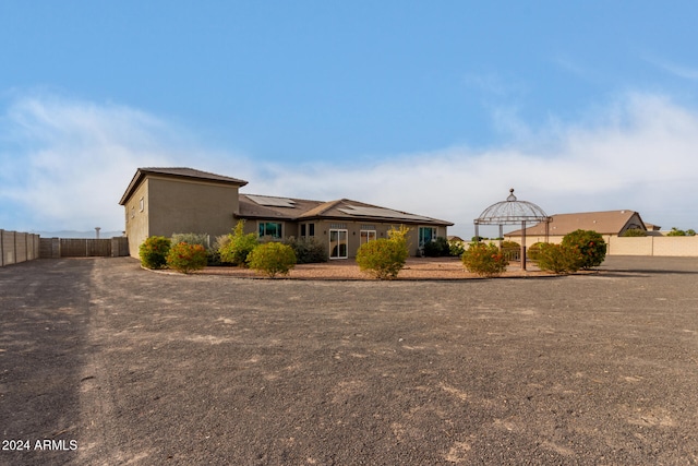 view of front of property featuring solar panels