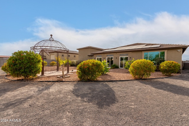 exterior space with a gazebo and solar panels