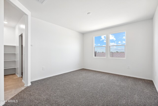 unfurnished room with carpet flooring