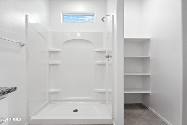 bathroom featuring a shower and vanity