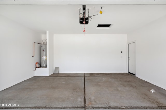 garage featuring a garage door opener and electric water heater