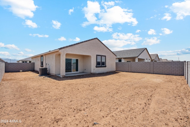 back of house with central AC unit and a patio area