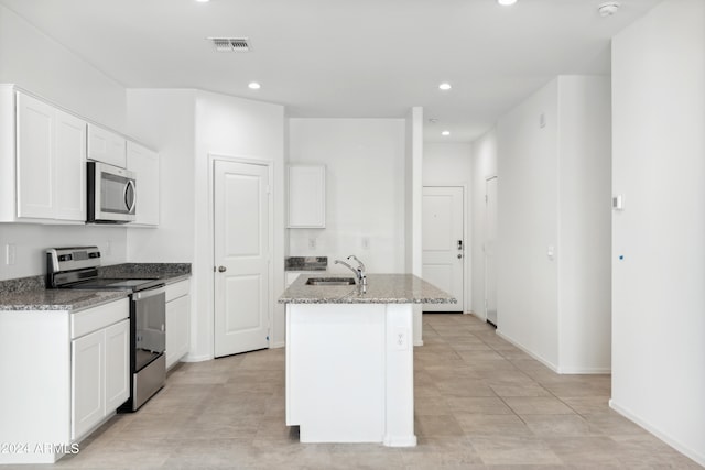 kitchen featuring white cabinetry, appliances with stainless steel finishes, sink, and an island with sink