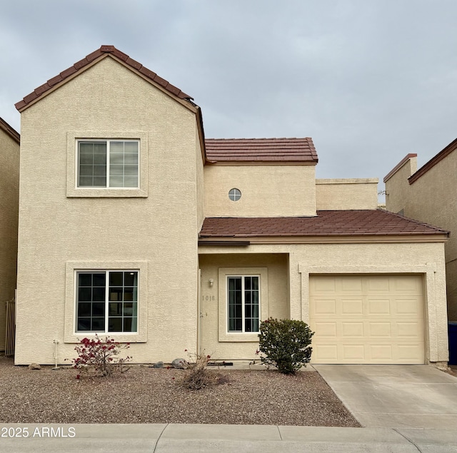 view of front of property featuring driveway, a tile roof, and stucco siding