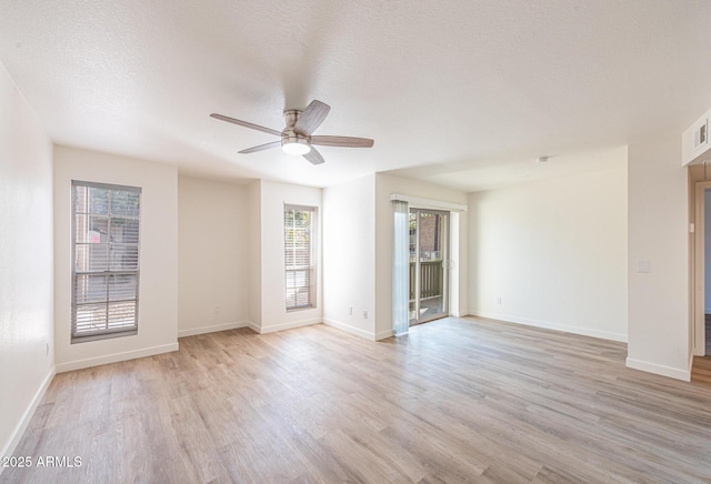 empty room featuring light wood-type flooring, a textured ceiling, and ceiling fan