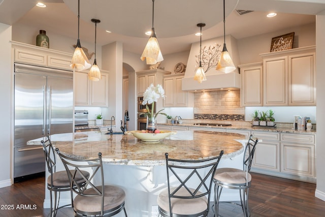 1617 E Copper Holw, Queen Creek, AZ 85140 - kitchen featuring appliances with stainless steel finishes, dark wood-style flooring, a kitchen breakfast bar, decorative backsplash, and recessed lighting