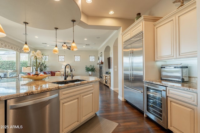 1617 E Copper Holw, Queen Creek, AZ 85140 - kitchen featuring appliances with stainless steel finishes, a sink, beverage cooler, cream cabinets, and dark wood-style floors
