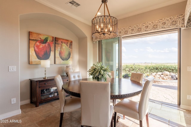 1617 E Copper Holw, Queen Creek, AZ 85140 - dining space with a chandelier, ornamental molding, baseboards, and stone finish floors