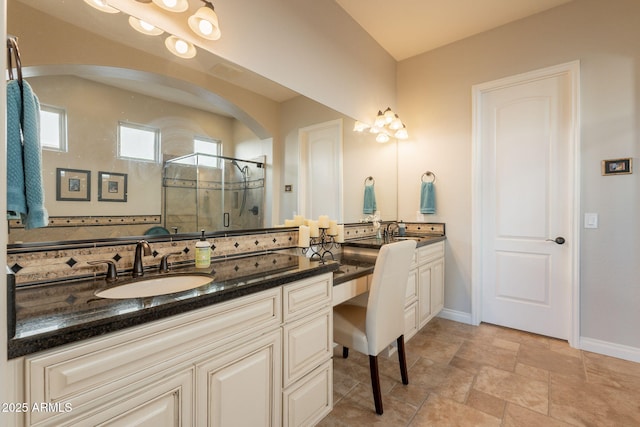 1617 E Copper Holw, Queen Creek, AZ 85140 - full bathroom with double vanity, a stall shower, baseboards, and stone finish floors