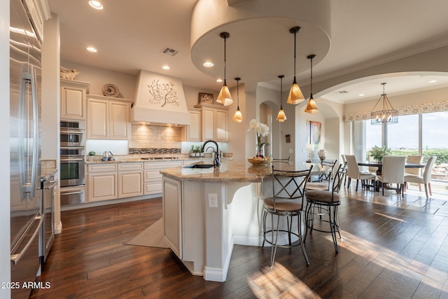 1617 E Copper Holw, Queen Creek, AZ 85140 - kitchen with a sink, custom range hood, stainless steel appliances, a kitchen breakfast bar, and dark wood-style flooring
