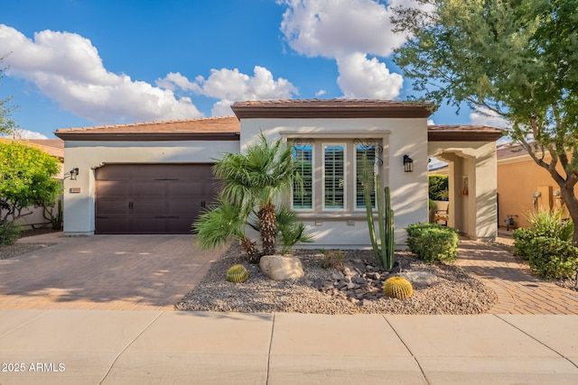 1617 E Copper Holw, Queen Creek, AZ 85140 - mediterranean / spanish-style home featuring decorative driveway, a garage, stucco siding, and a tiled roof