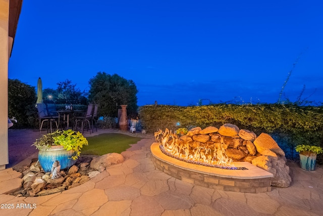 1617 E Copper Holw, Queen Creek, AZ 85140 - patio at twilight featuring a patio area and an outdoor fire pit