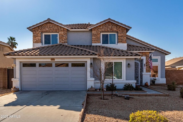 view of front of home with stone siding, fence, concrete driveway, and stucco siding