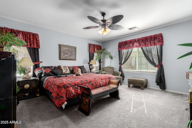 carpeted bedroom with baseboards, visible vents, and a ceiling fan