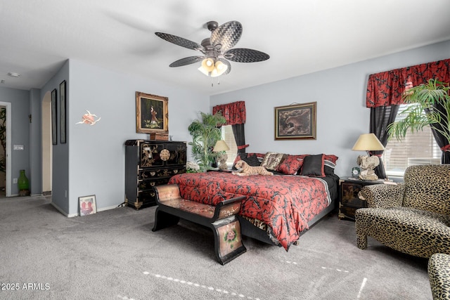 carpeted bedroom with a ceiling fan and baseboards