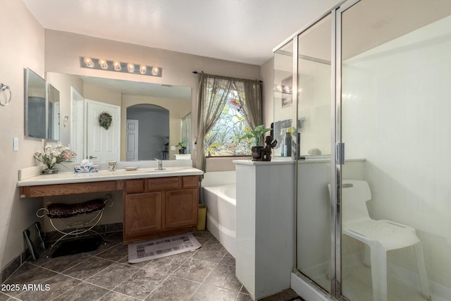 full bath featuring a stall shower, vanity, and a bath