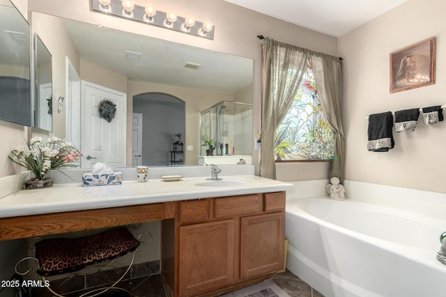 full bathroom with visible vents, vanity, a shower stall, and a bath