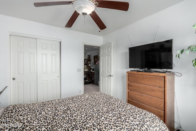 carpeted bedroom with a closet and ceiling fan