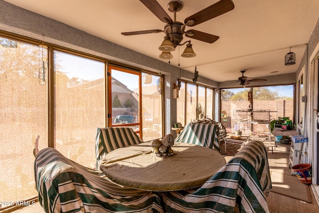 sunroom / solarium featuring ceiling fan and plenty of natural light