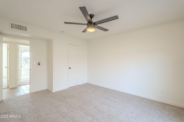 interior space featuring light colored carpet, visible vents, and baseboards