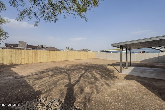 view of yard with fence and a patio