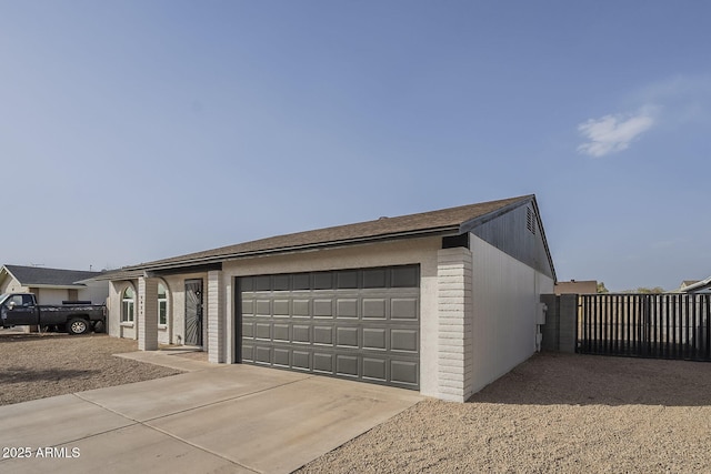 garage with concrete driveway