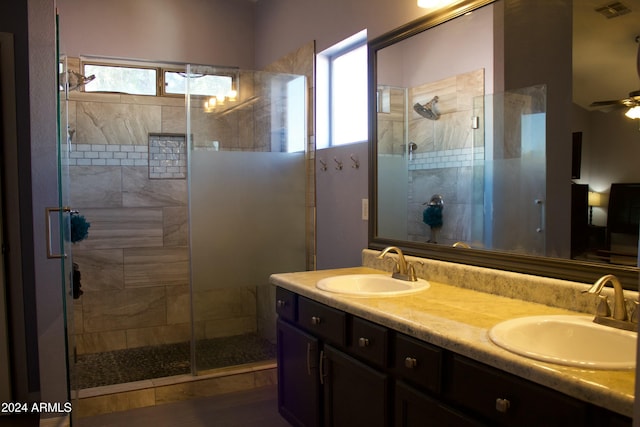 bathroom with walk in shower, vanity, plenty of natural light, and ceiling fan