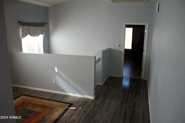 corridor with dark hardwood / wood-style flooring