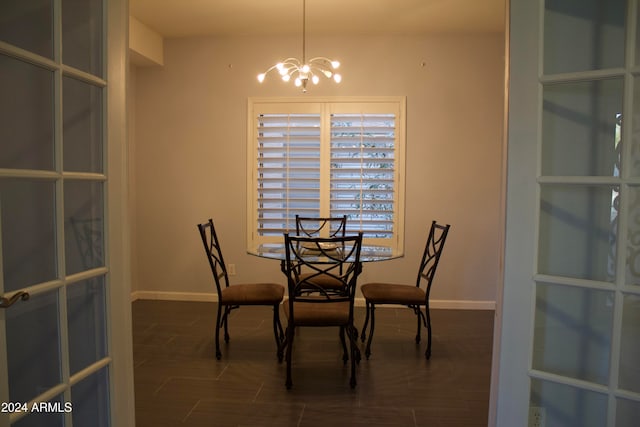 unfurnished dining area featuring a notable chandelier and dark hardwood / wood-style floors