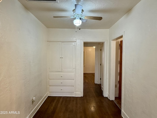 hallway featuring dark hardwood / wood-style flooring and a textured ceiling