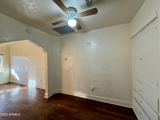 unfurnished room featuring dark hardwood / wood-style flooring and ceiling fan