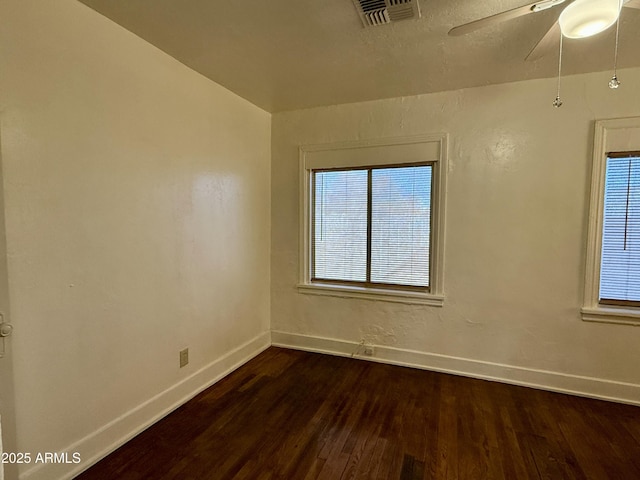 unfurnished room with dark hardwood / wood-style floors and ceiling fan