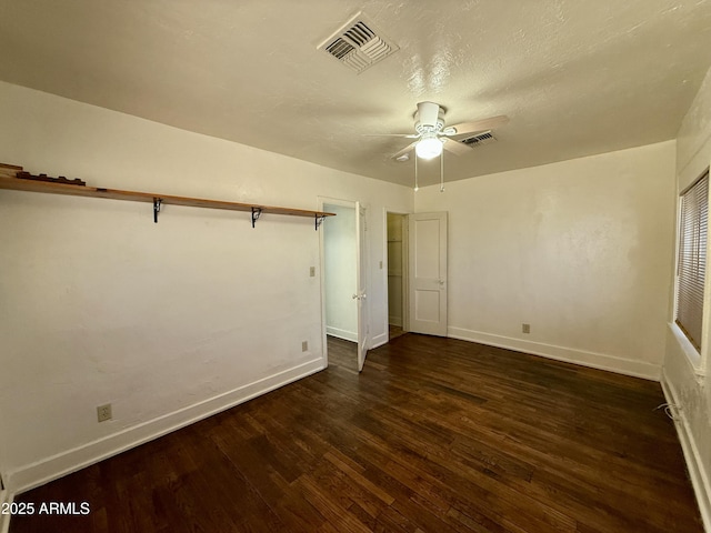 unfurnished bedroom featuring ceiling fan and dark hardwood / wood-style flooring