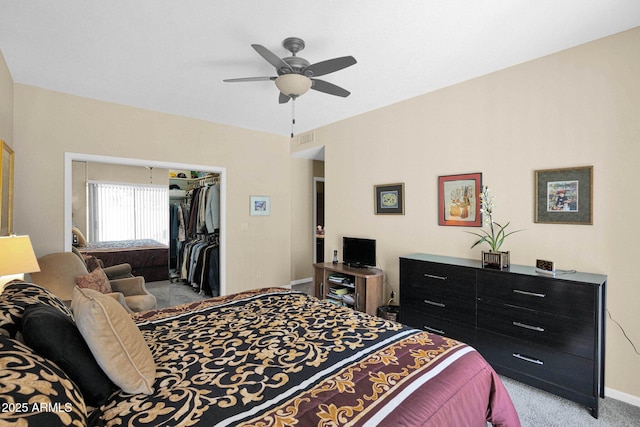 carpeted bedroom with ceiling fan and a closet