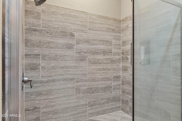 bathroom with tiled shower