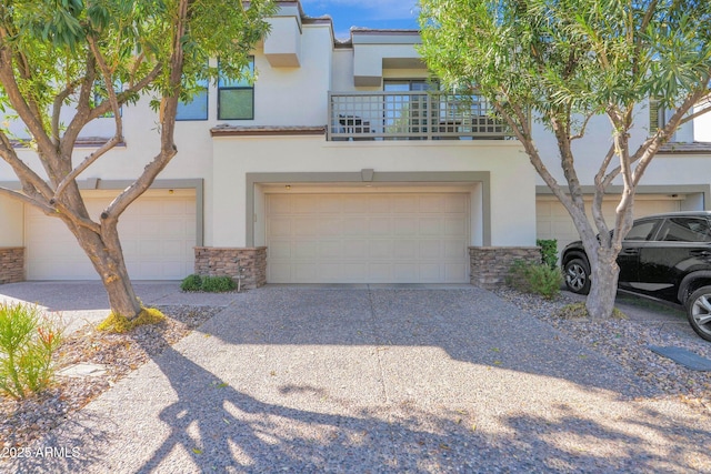 view of property featuring a garage and a balcony