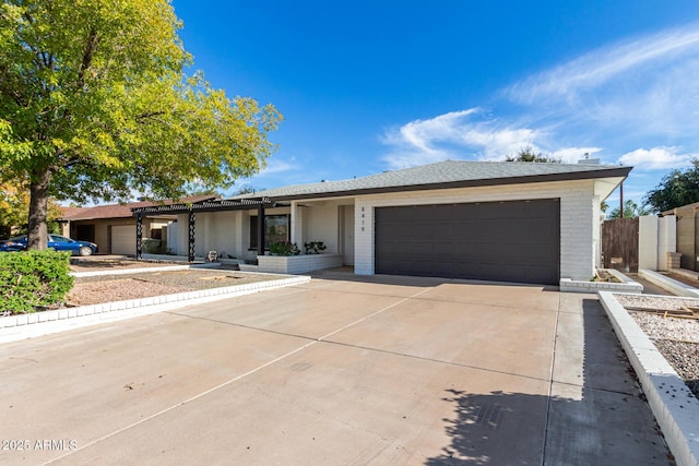 single story home featuring a garage, driveway, and brick siding